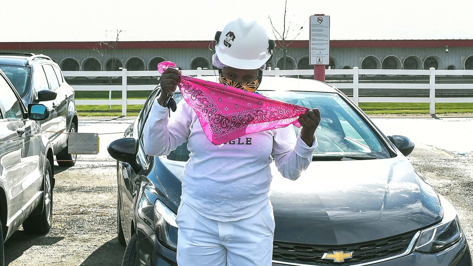 A Tyson Foods employee puts on a second protective mask outside of the company’s meat processing plant.