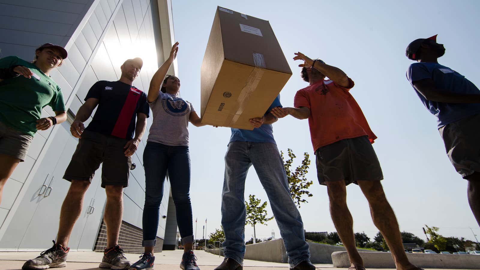 Volunteers move boxes of shoes donated after Hurricane Harvey.