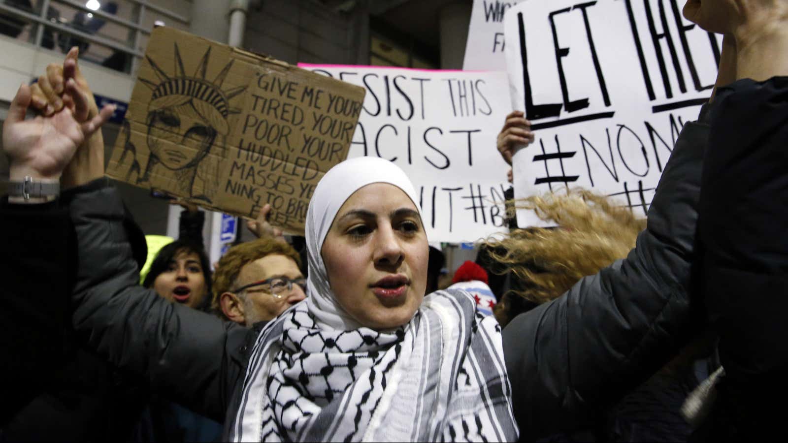 Demonstrators converge outside Terminal 5 of O’Hare airport Sunday, Jan. 29, 2017, in Chicago.