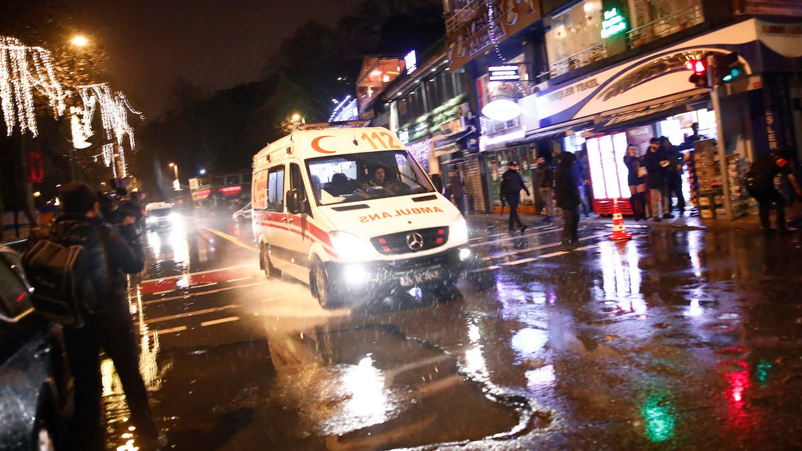 An ambulance rushes from the scene of an attack in Istanbul, early Sunday, Jan. 1, 2017.