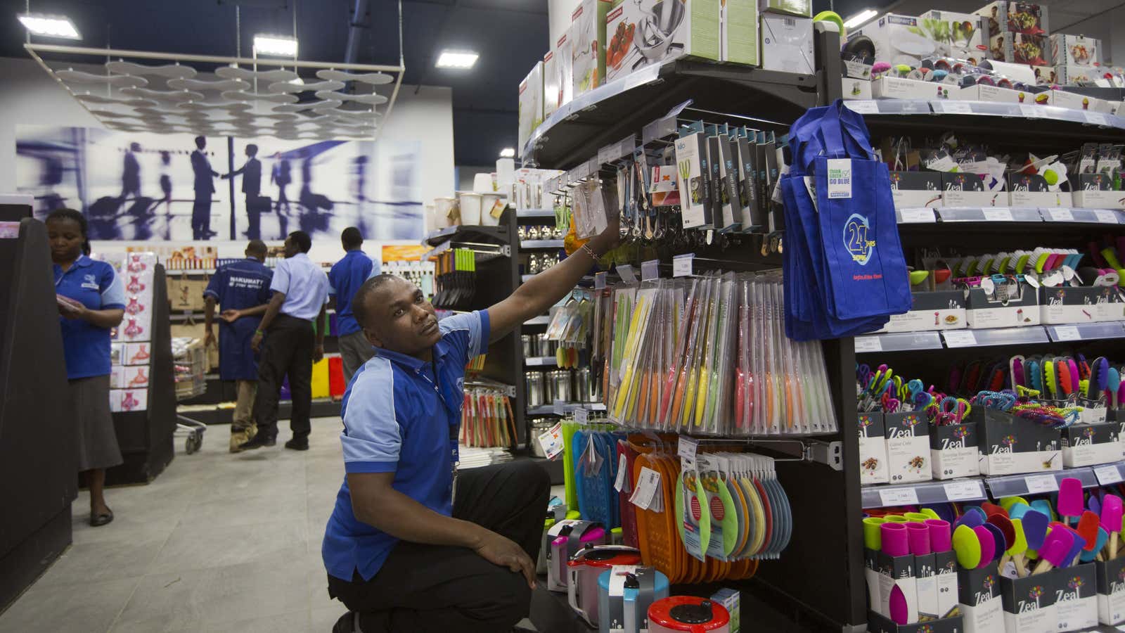 Employees of the supermarket chain Nakumatt stock shelves in Nairobi, Kenya.