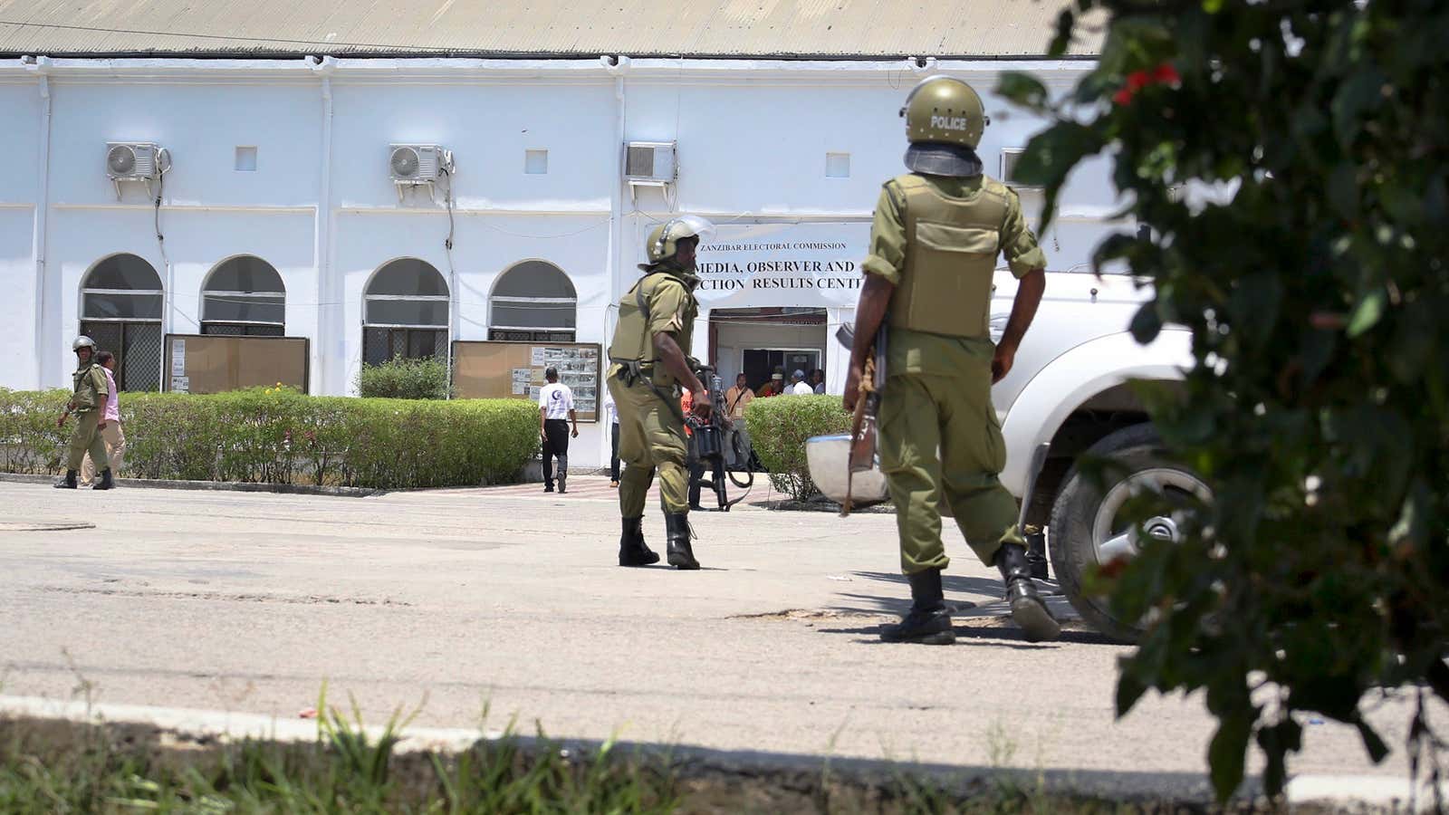 Riot police take positions outside the electoral results center in Stone Town, Zanzibar.