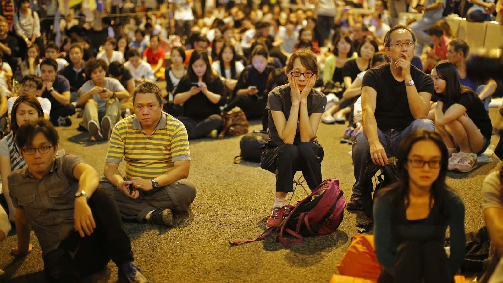 Protesters in Hong Kong listen to speeches after talks planned for Friday between demonstrators and the government were called off.