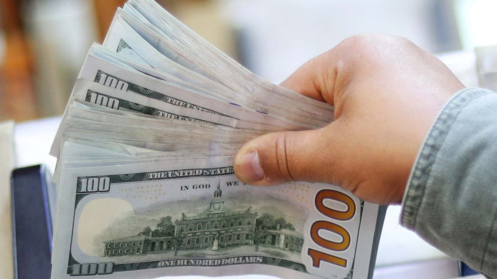 An employee counts U.S. dollar bills at a money exchange office in central Cairo, Egypt, March 20, 2019.