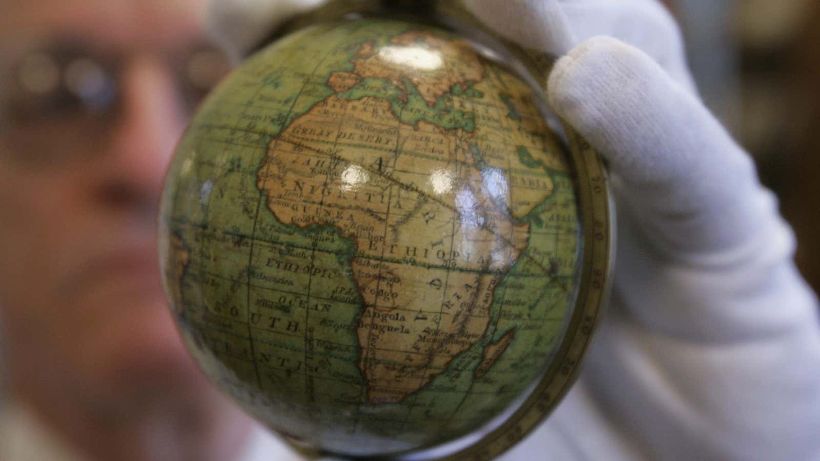 Robert W. Karrow Jr., curator of maps at the Newberry Library in Chicago, holds an early 19th century pocket globe produced in England Wednesday, April 18, 2007, at the Newberry Library in Chicago. The softball-sized globe will be part of an exhibition called “Maps: Finding Our Place in the World,” opening Nov. 2 at Chicago’s Field Museum, featuring some of the world’s most famous maps. (AP Photo/Charles Rex Arbogast)