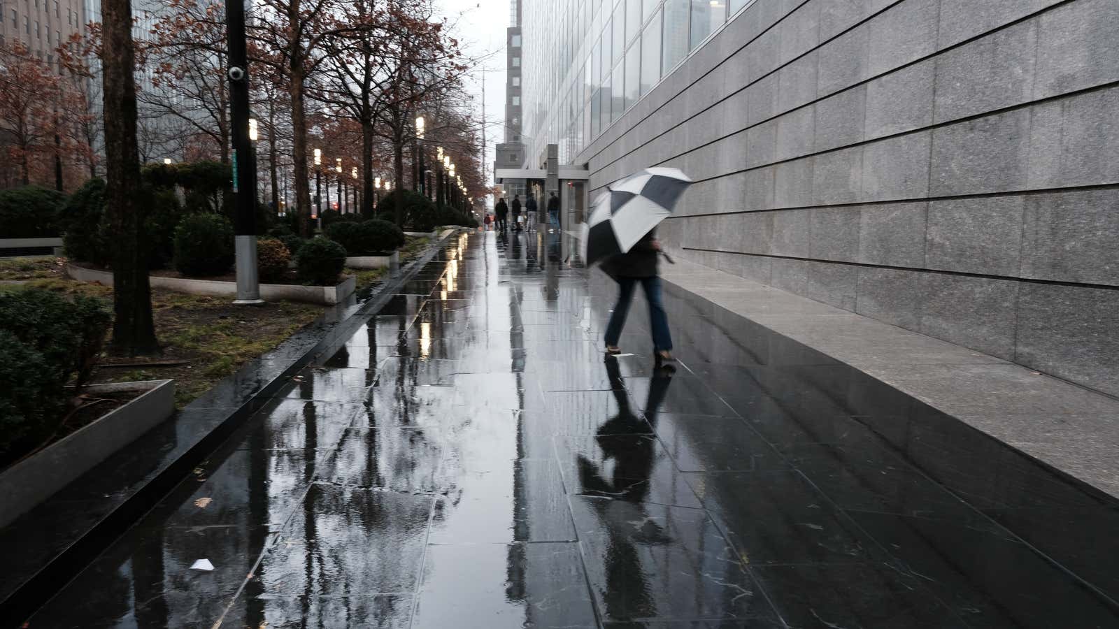 People walk by Goldman Sachs headquarters in Manhattan on December 16, 2022 in New York City.