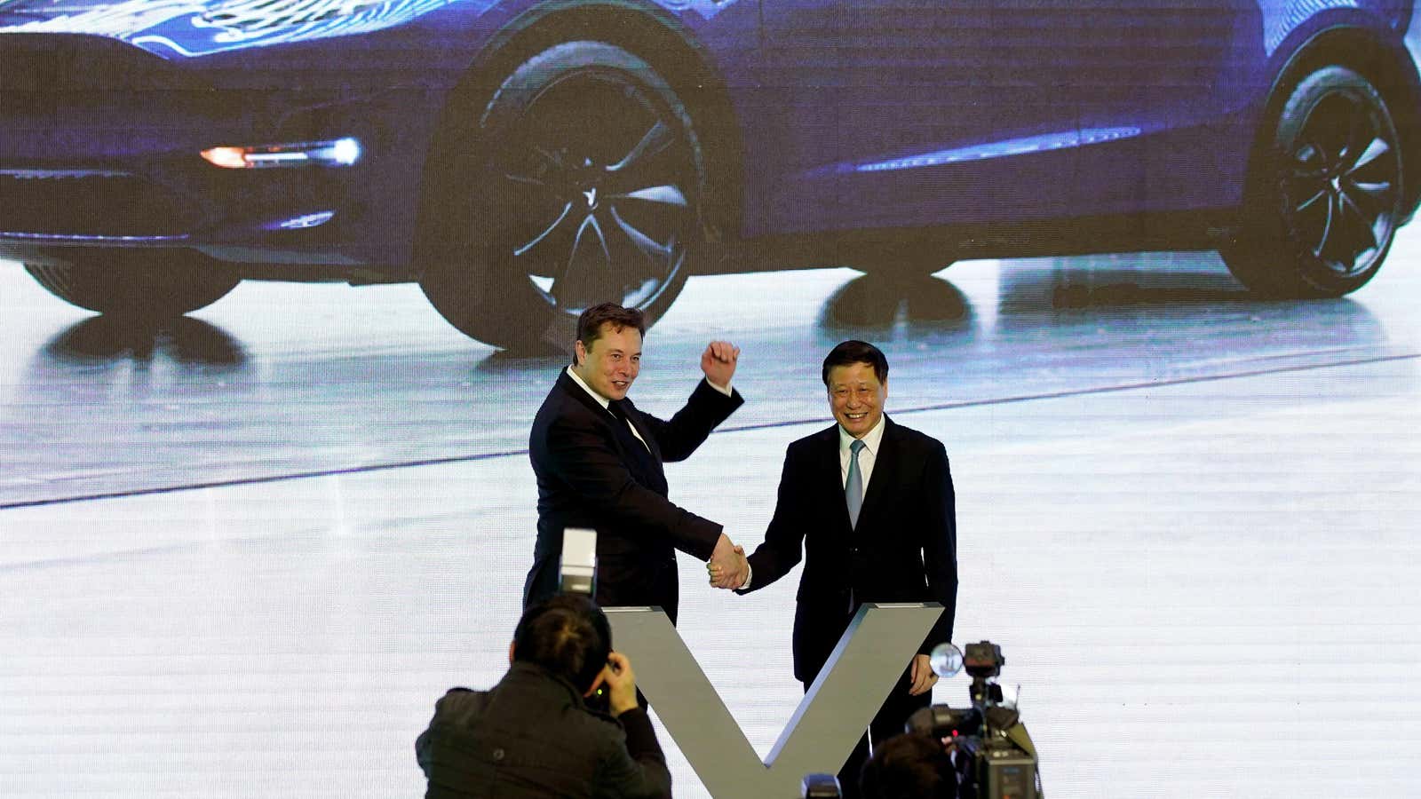 Elon Musk celebrates a Tesla factory opening with the Shanghai Mayor Ying Yong.