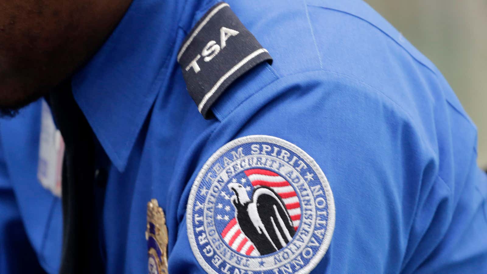 In this photo taken Oct. 30, 2014, a TSA shoulder patch is shown on the uniform of a Transportation Security Administration officer at John F.…