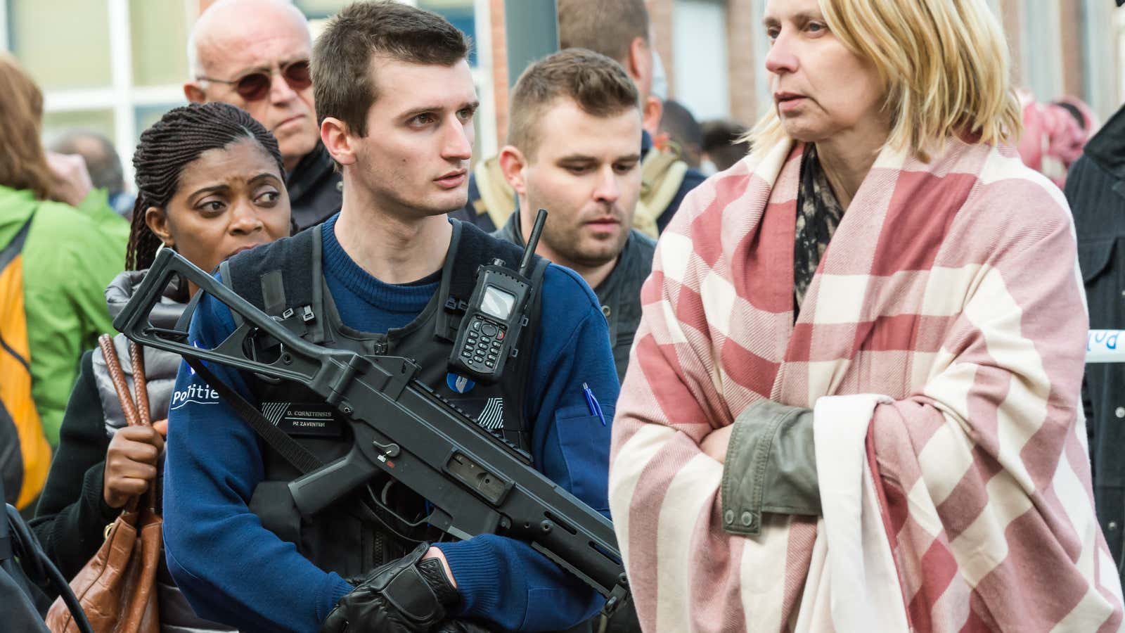 A police officer stands guard as people are evacuated from Brussels airport.