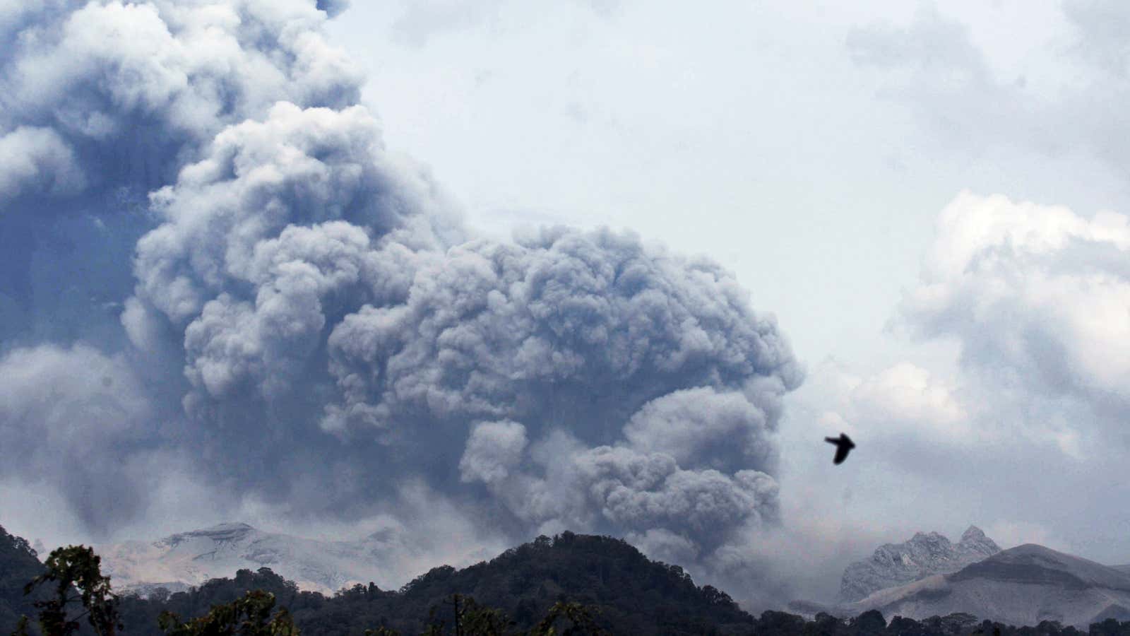 Mount Kelud erups, as seen from Anyar village in Blitar East Java, Indonesia, Friday, Feb. 14, 2014. Volcanic ash from a major eruption in Indonesia…