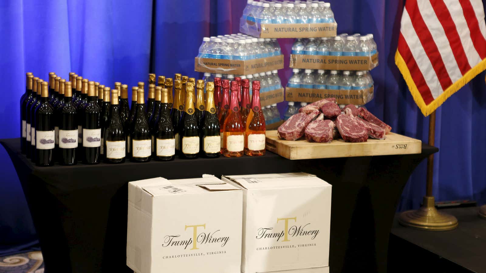 Steaks and chops described as “Trump meat” are shown near the podium with Trump branded wines.