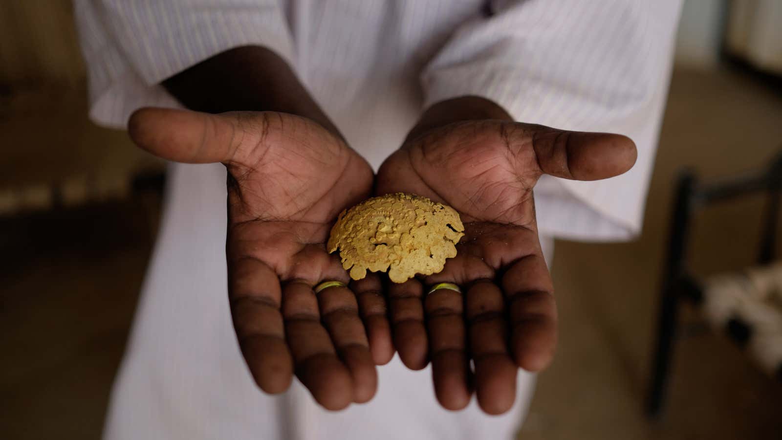 Salahuddein Salah, site manager of the Al-Etimad mine, displays gold derived through the mercury and cyanide process.