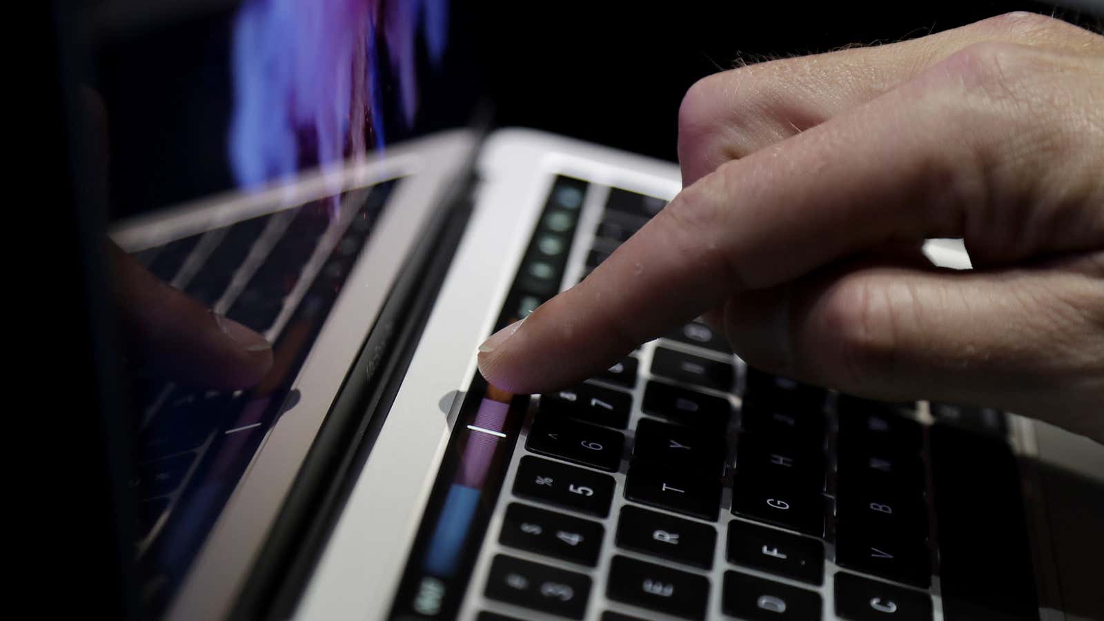 A guest looks at the Touch Bar on a MacBook computer shown in a demo room following the announcement of new products at Apple headquarters Thursday, Oct. 27, 2016, in Cupertino, Calif. (AP Photo/Marcio Jose Sanchez)