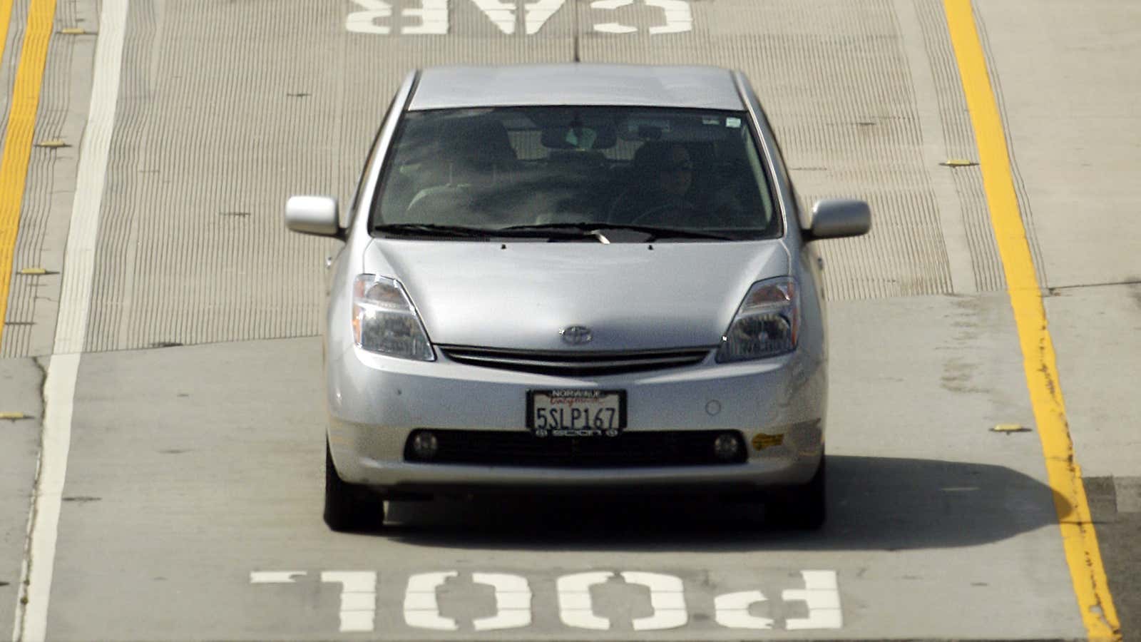 In a June 28, 2011 photo, a Toyota Prius hybrid auto bearing a California DMV decal on its left front bumper are seen in carpool…