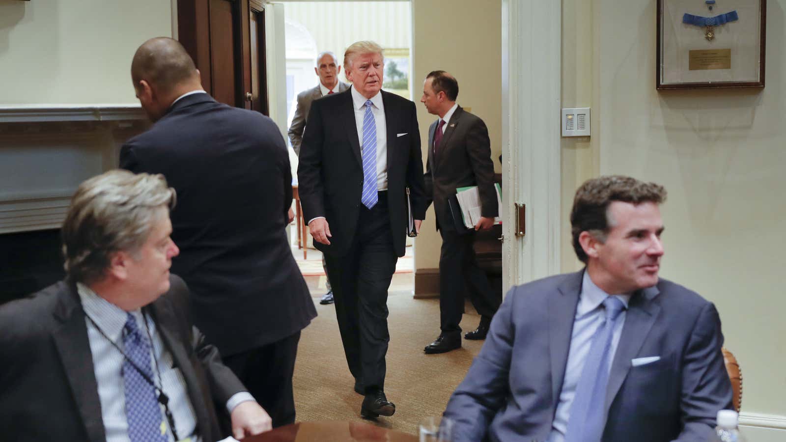 At center, US president Trump, and seated at right, Under Armour CEO Kevin Plank.