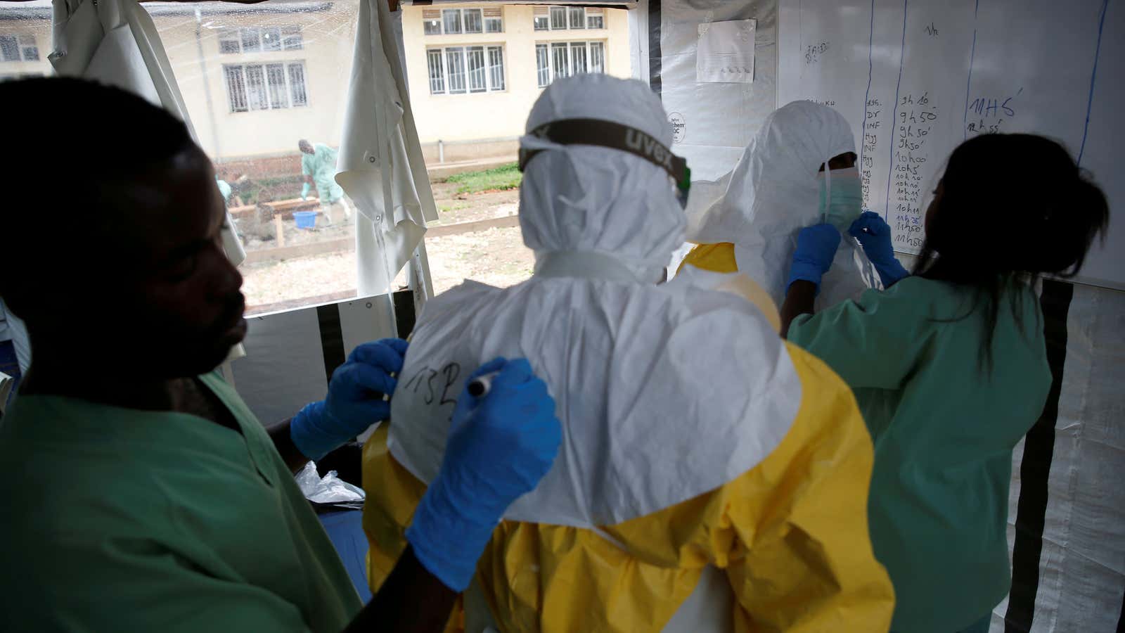 Health workers dress in Ebola protective suits at an Ebola transit centre in the town of Katwa near Butembo, in the Democratic Republic of Congo