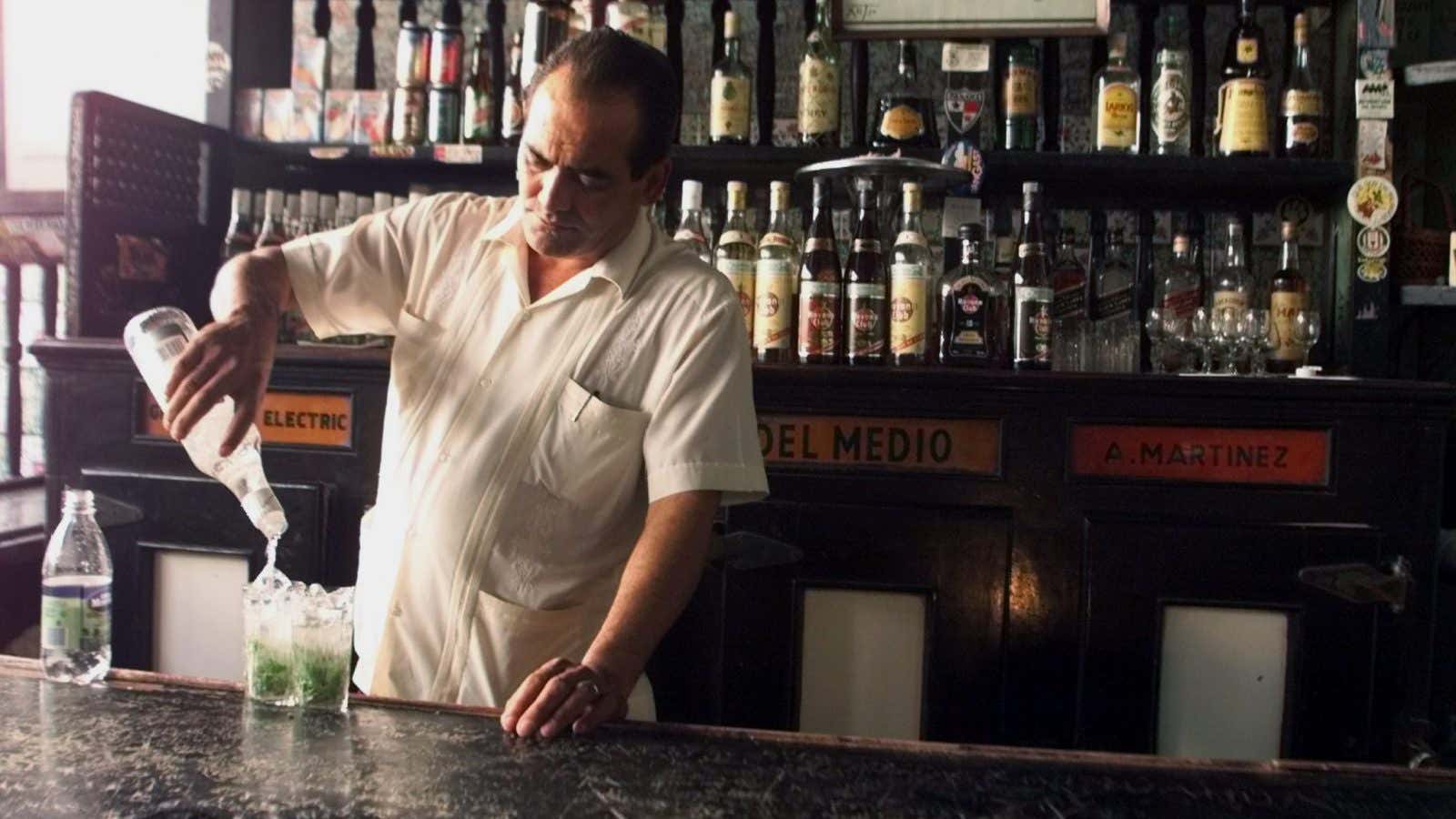 A Cuban bartender prepares a traditional “mojito”, a drink mixed with rum, mint and sugar, in the “Bodeguita del Medio” bar in Old Havana City,…