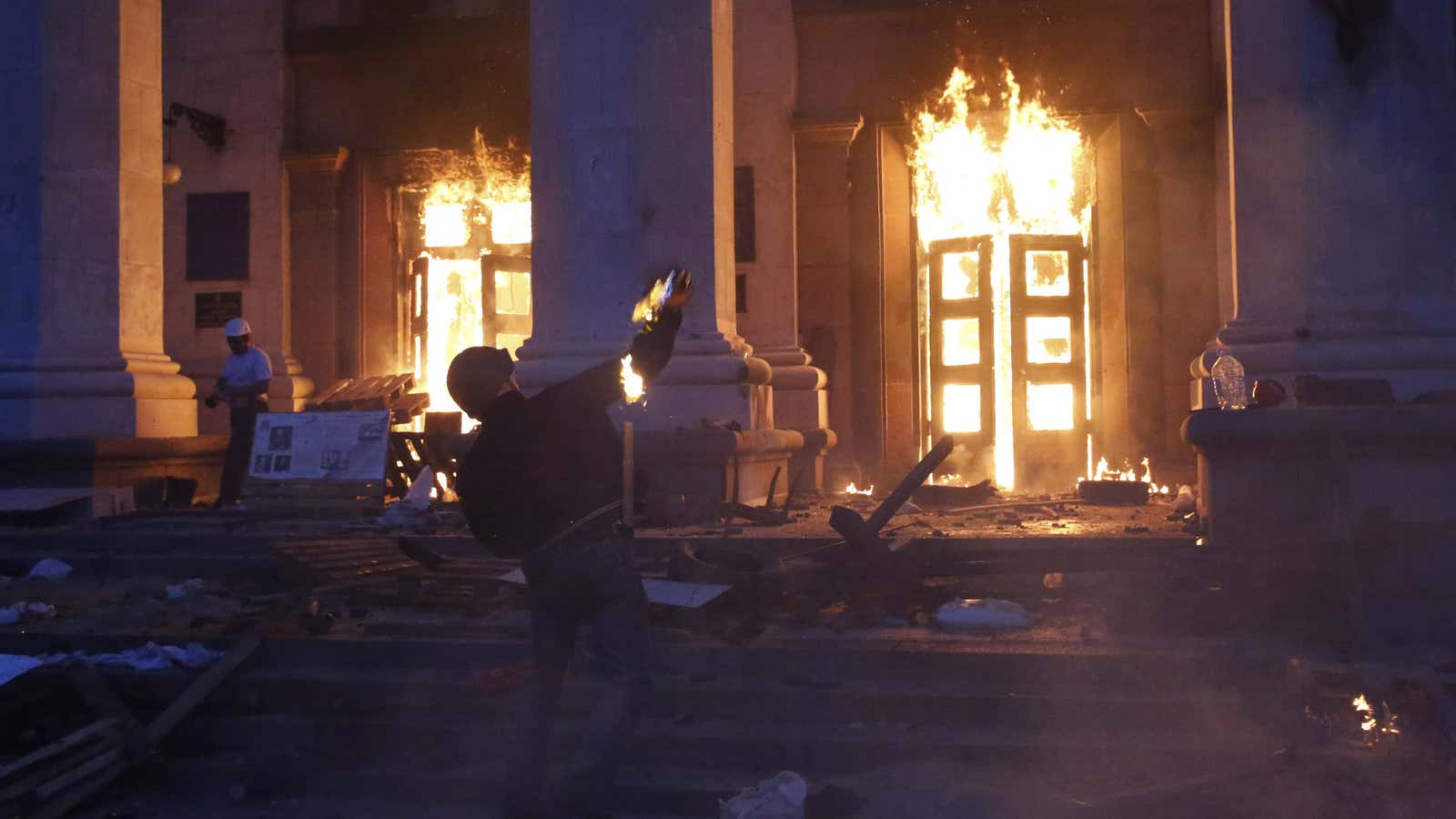 A protester throws a petrol bomb at the trade union building in Odessa on May 2.