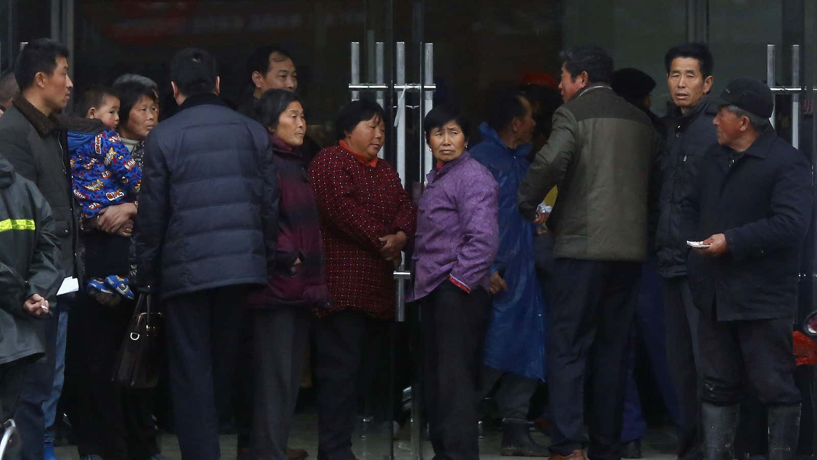 Locals waiting outside Jiangsu Sheyang Rural Commercial Bank in Jiangsu province.