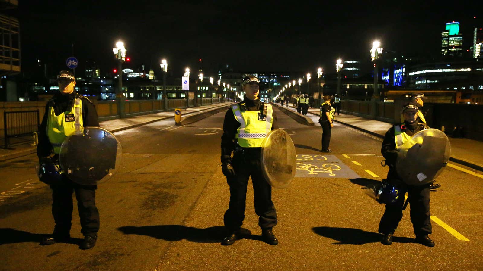 Police officers guard the approach to Southwark Bridge.