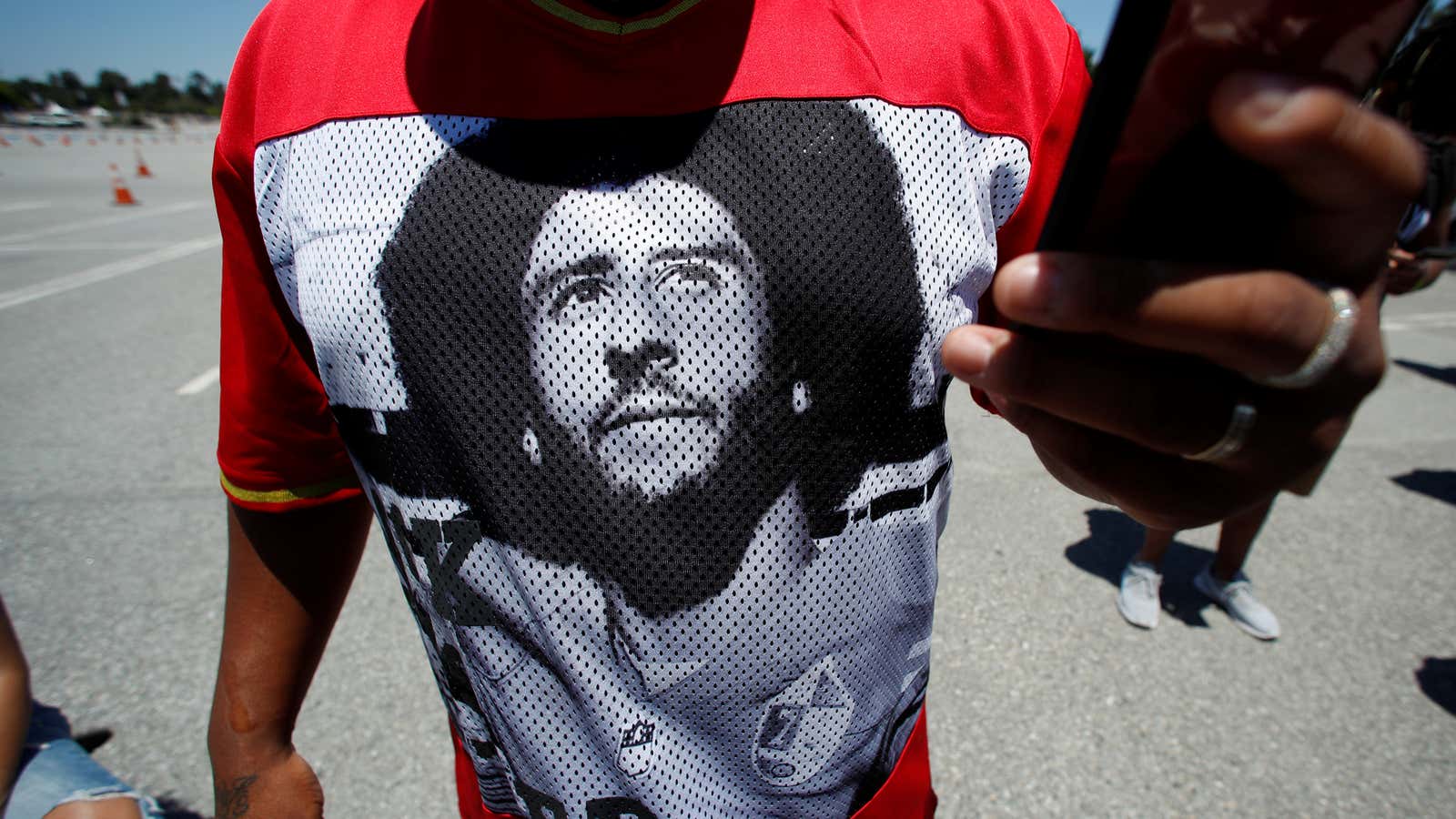 A protester wears a t-shirt with a picture of Colin Kaepernick during a protest against police brutality and racial inequality in the aftermath of the…