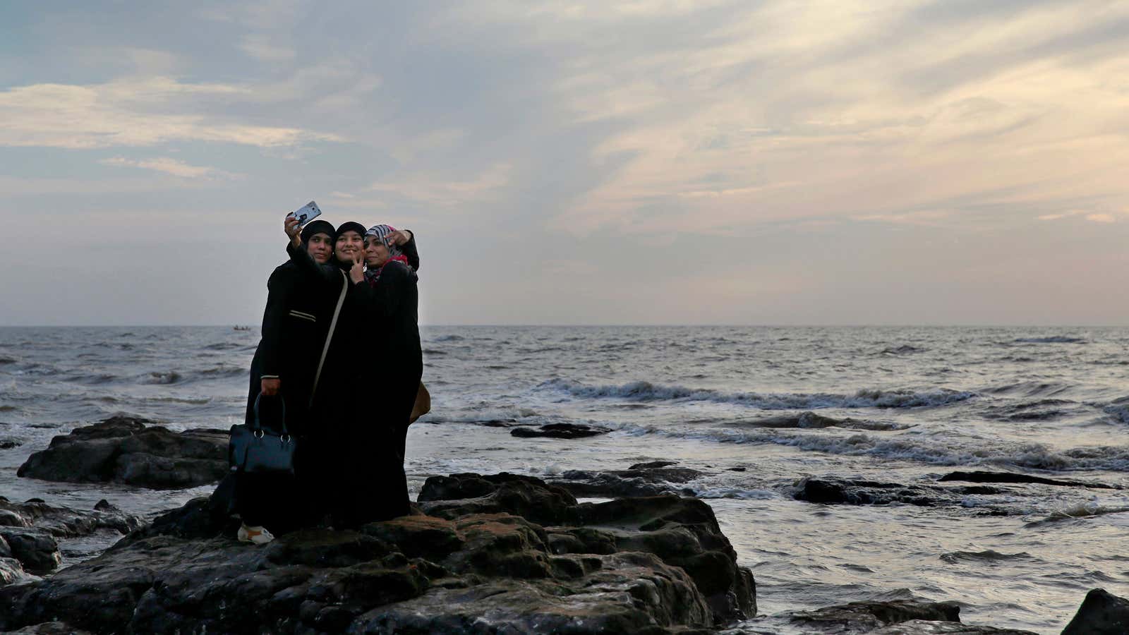 Indian students snap a selfie on Mumbai’s coastline.