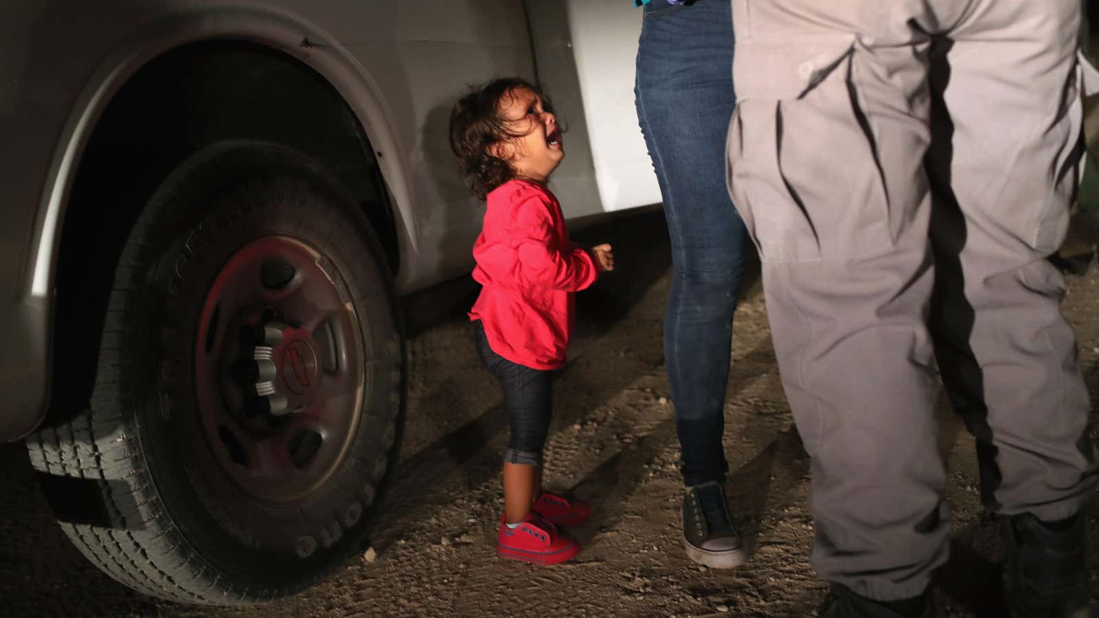 MCALLEN, TX – JUNE 12: A two-year-old Honduran asylum seeker cries as her mother is searched and detained near the U.S.-Mexico border on June 12,…