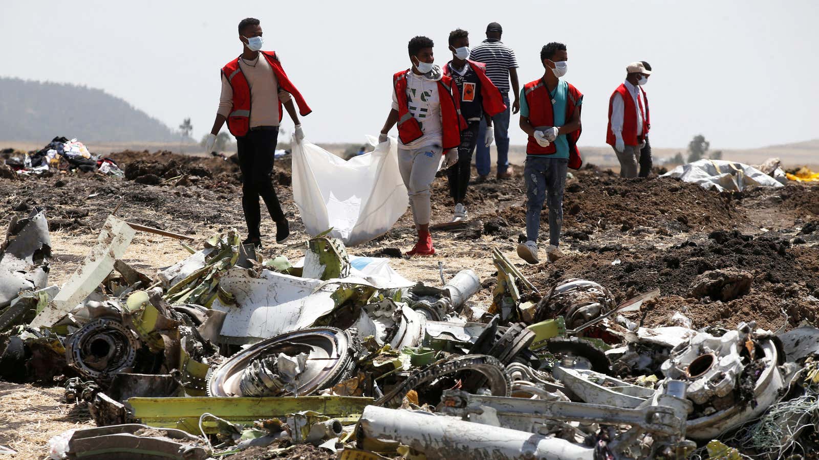 Ethiopian Red Cross workers carry a body bag with the remains of Ethiopian Airlines Flight ET 302 plane crash victims at the scene of the crash, near the town of Bishoftu, southeast of Addis Ababa, Ethiopia Mar. 12, 2019.