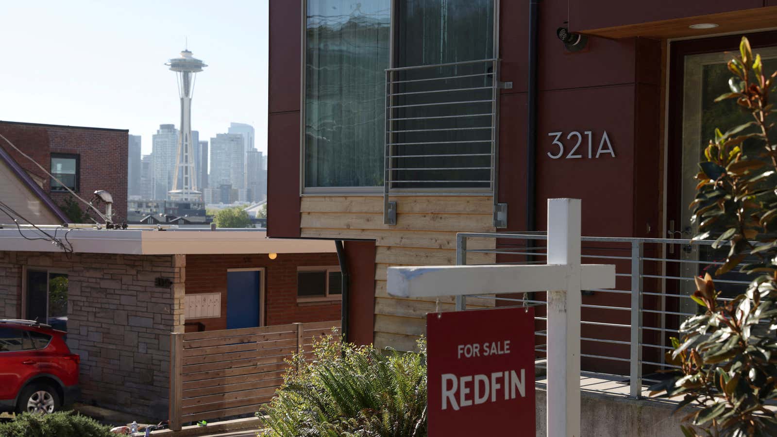 A “For Sale” sign is posted outside a residential home in Seattle.