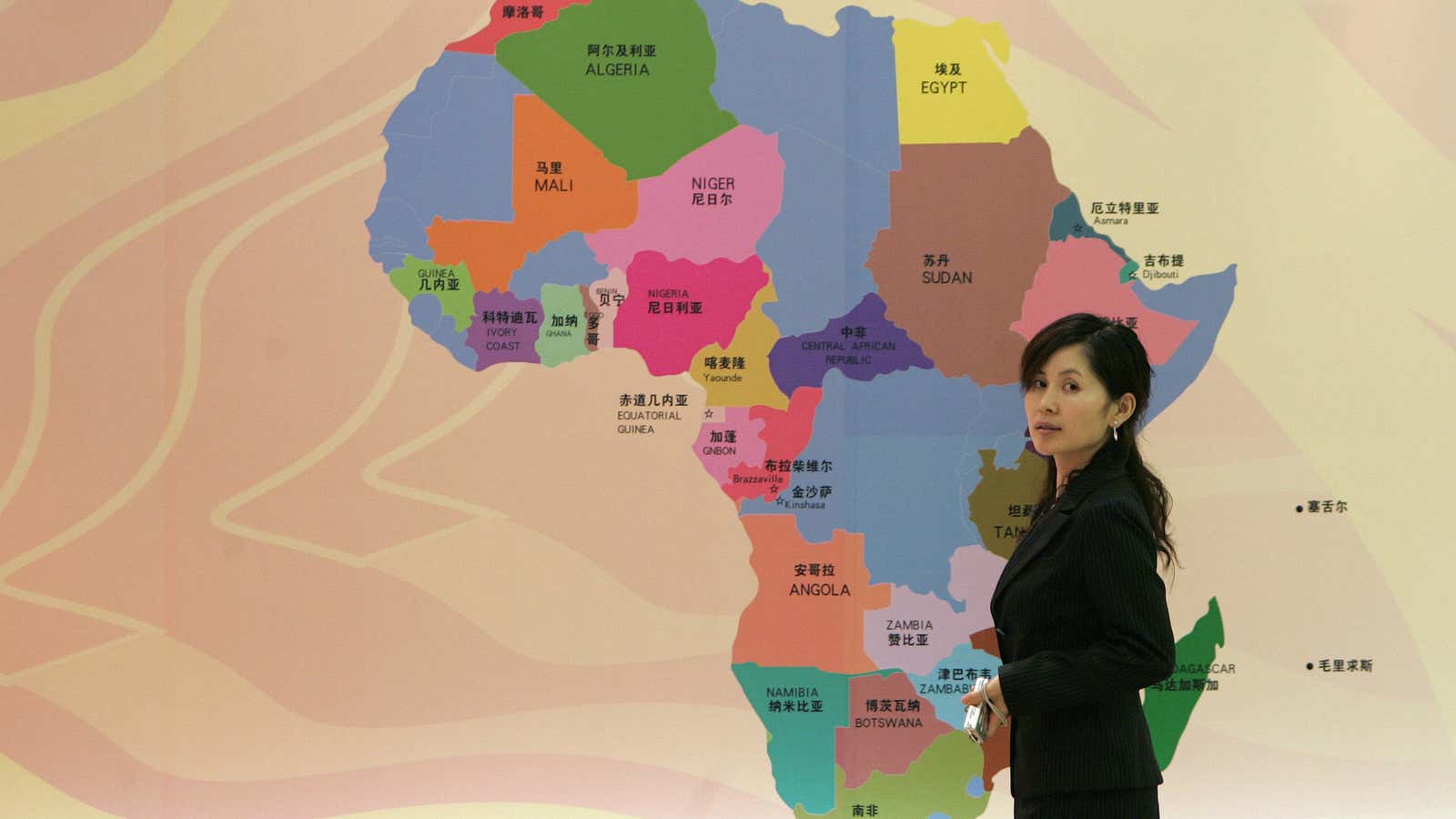 A visitor walks past a map of Africa at a meeting of the Africa Development bank in Shanghai in 2007.