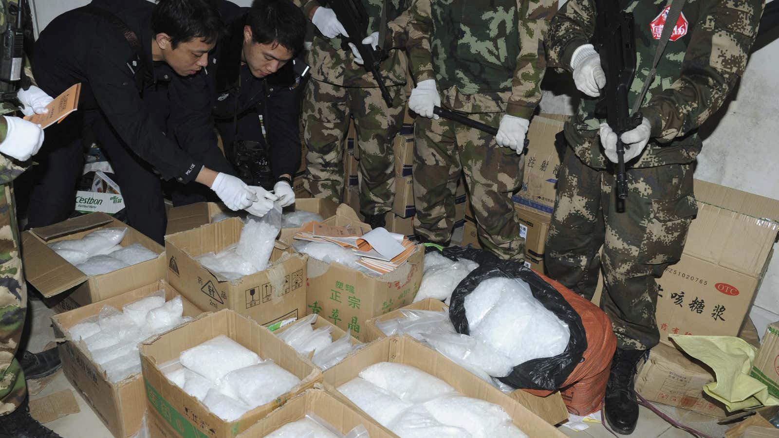 Chinese police examine seized methamphetamine in Guangdong Province.