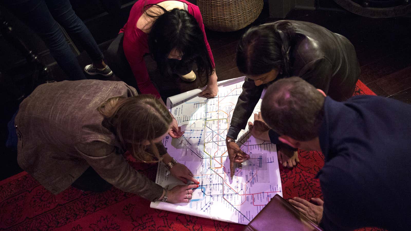 People work to find clues and solve puzzles to escape from a Sherlock Holmes-themed escape room in Alexandria, Virginia October 17, 2015. Escape rooms are the latest entertainment phenomena to seize the United States, where people break out of locked rooms using their smarts, or any that the friends, family members or strangers interred with them may possess. Picture taken October 17, 2015. To match Feature ENTERTAINMENT-ESCAPEROOM/REUTERS/Joshua Roberts