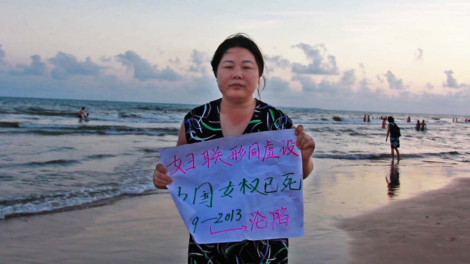 “Hooligan Sparrow” holds up a sign that says “China’s women’s rights are dead.”