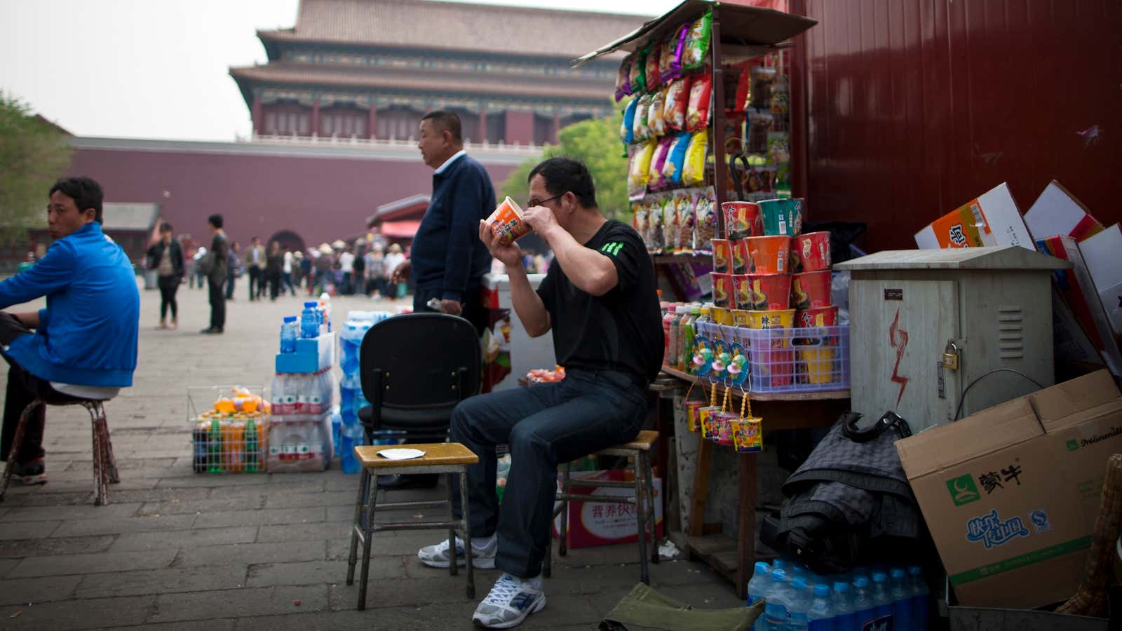 A Chinese man eats instant noodle at a store set up inside Forbidden City in Beijing, China Thursday, April 28, 2011. (AP Photo/Andy Wong)