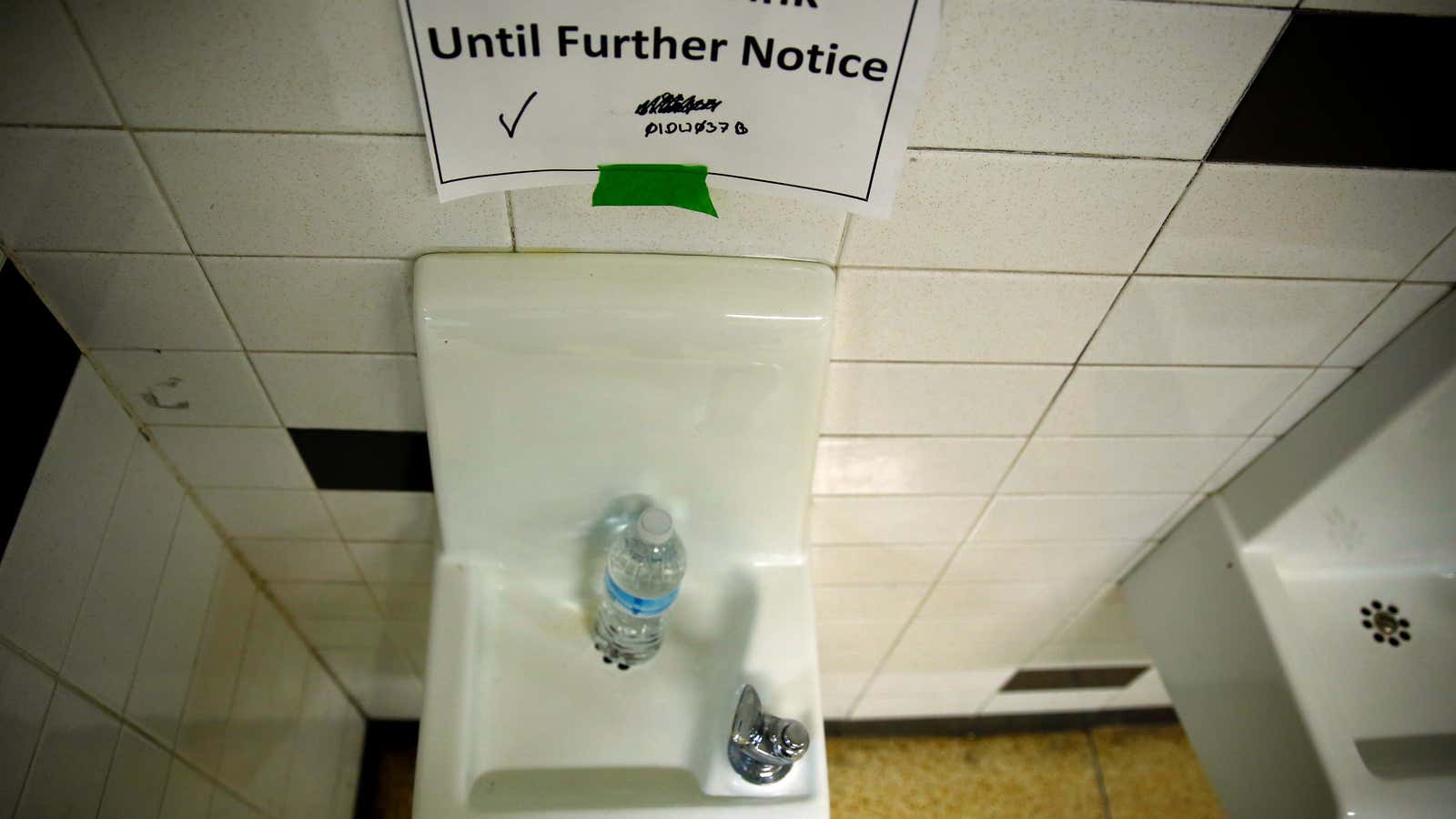 A sign is seen next to a water dispenser in Flint, Michigan in 2016.