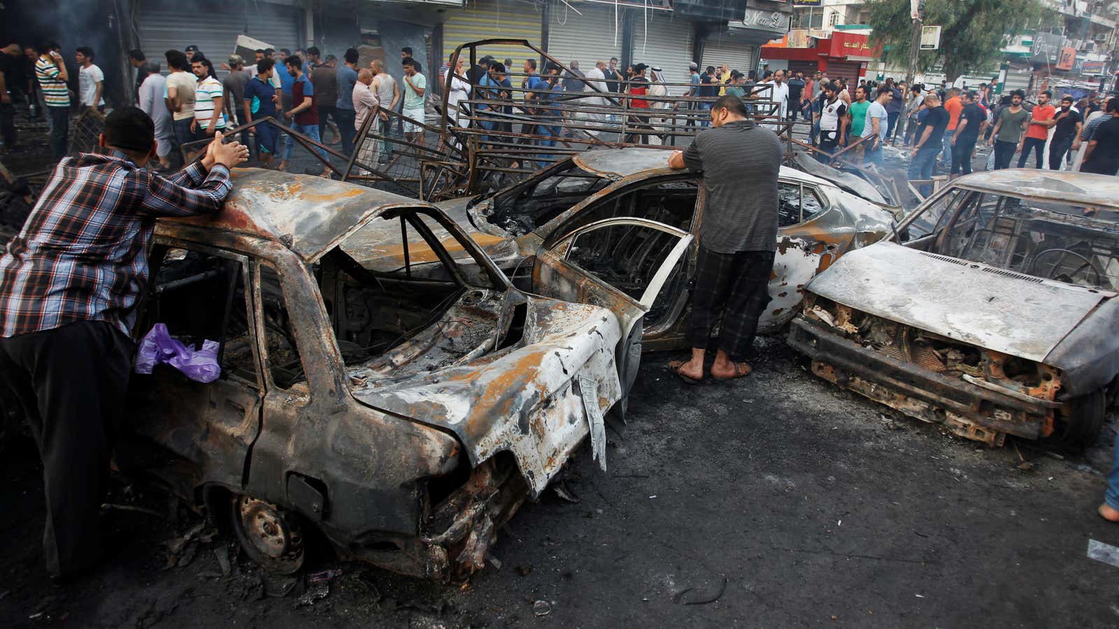 Civilians in Karrada gather at the scene’s aftermath.