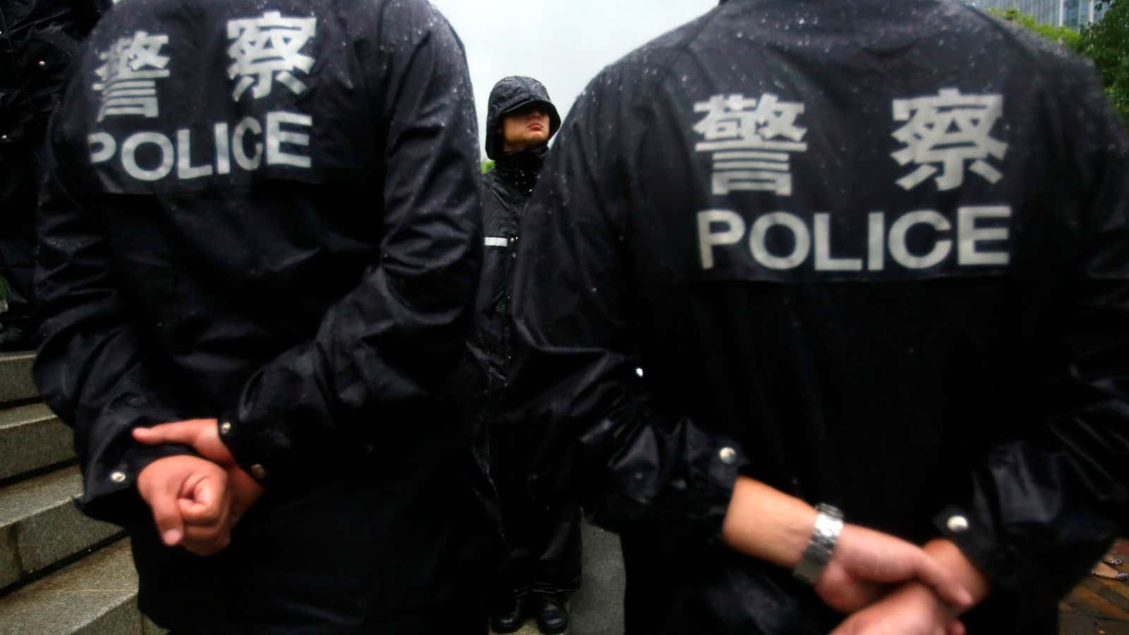 Police outside a court in Hefei, China, where the murder trial of Gu Kailai, the wife of ousted Chinese politician Bo Xilai, took place in August