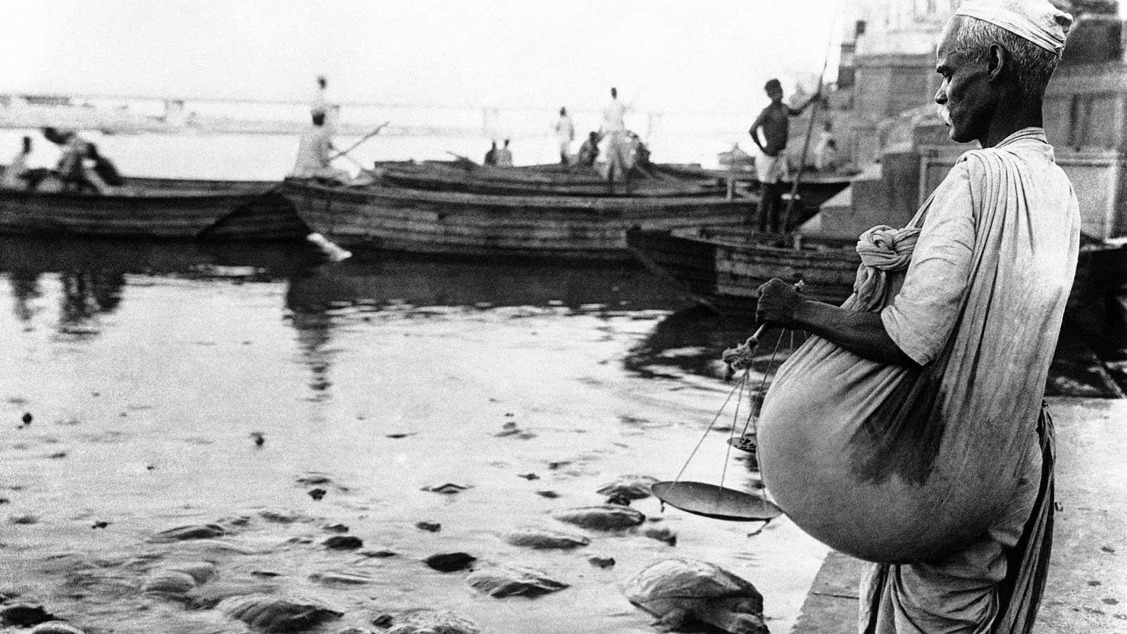 The tortoise feeder tending his charges at the river bank in India around Nov. 20, 1930. The official feeder goes to the river daily with…