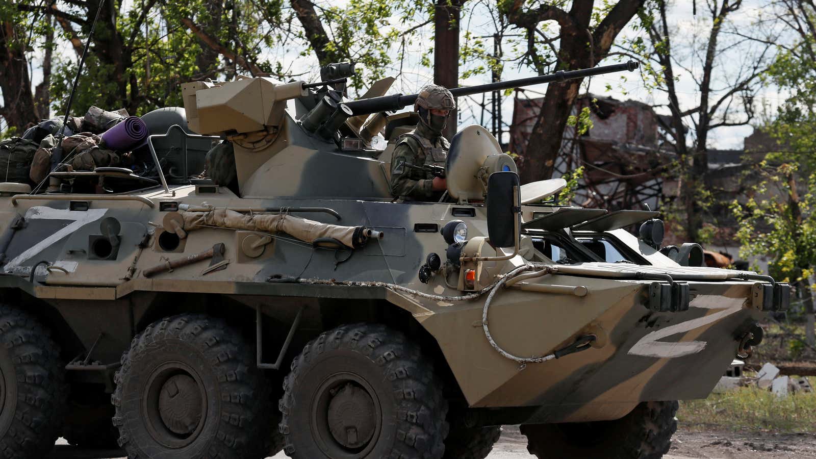 A pro-Russia tank escorting buses of Ukrainian troops out of Mariupol.