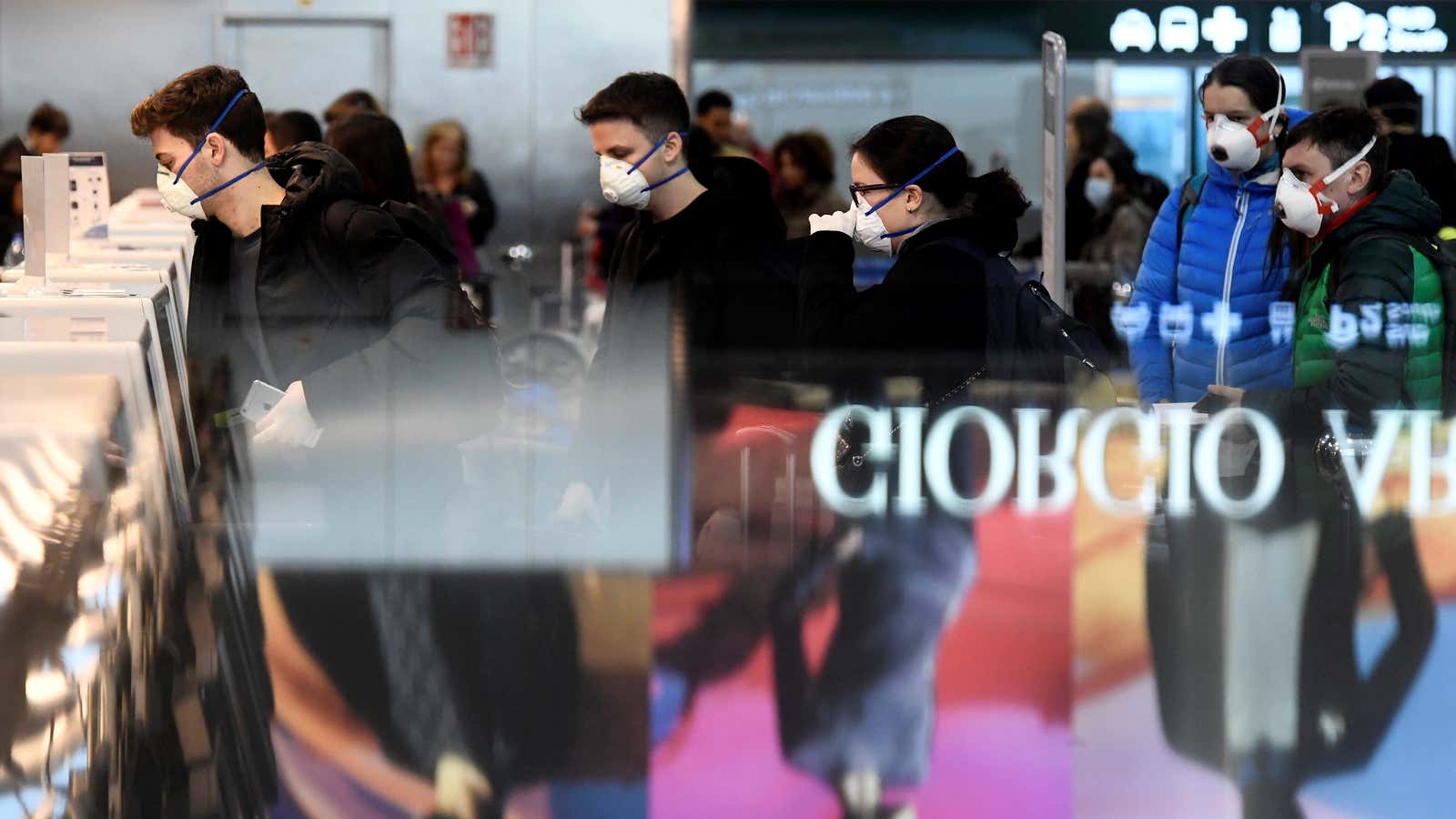 Travellers queue at Malpensa airport in Milan.