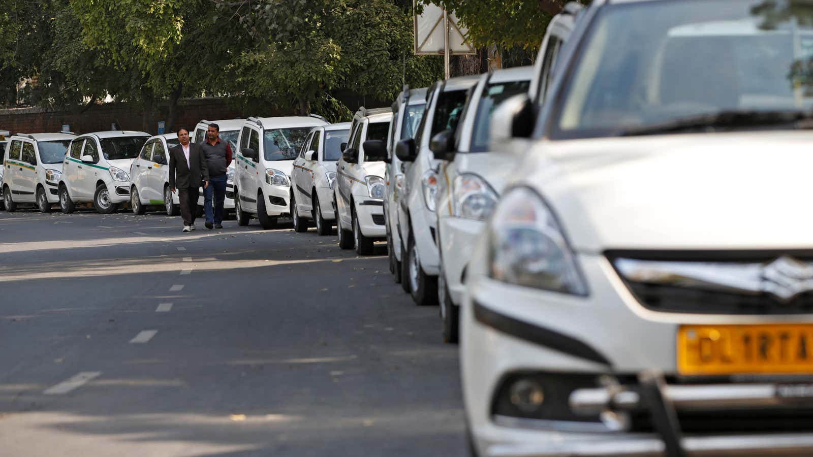 Drivers of Uber and Ola walk next to their parked vehicle’s during a protest in New Delhi, India, February 14, 2017. – RC16FF2E4AD0