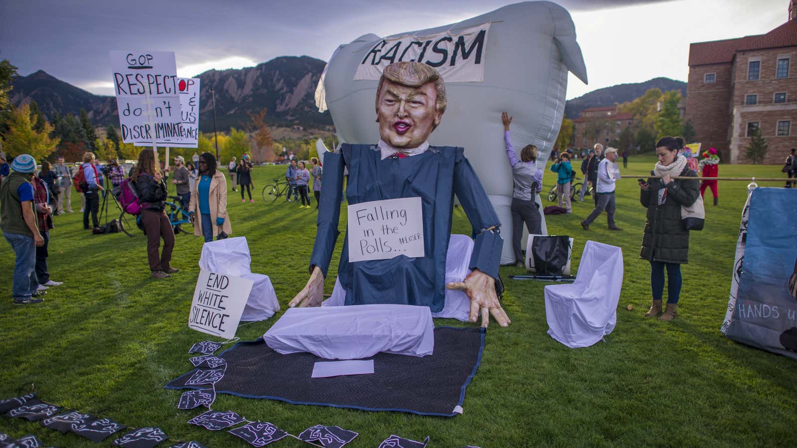 Students and protesters gather at the “Free Speech Zone” located at the University of Colorado’s Business Field as candidates gather across the street for a…