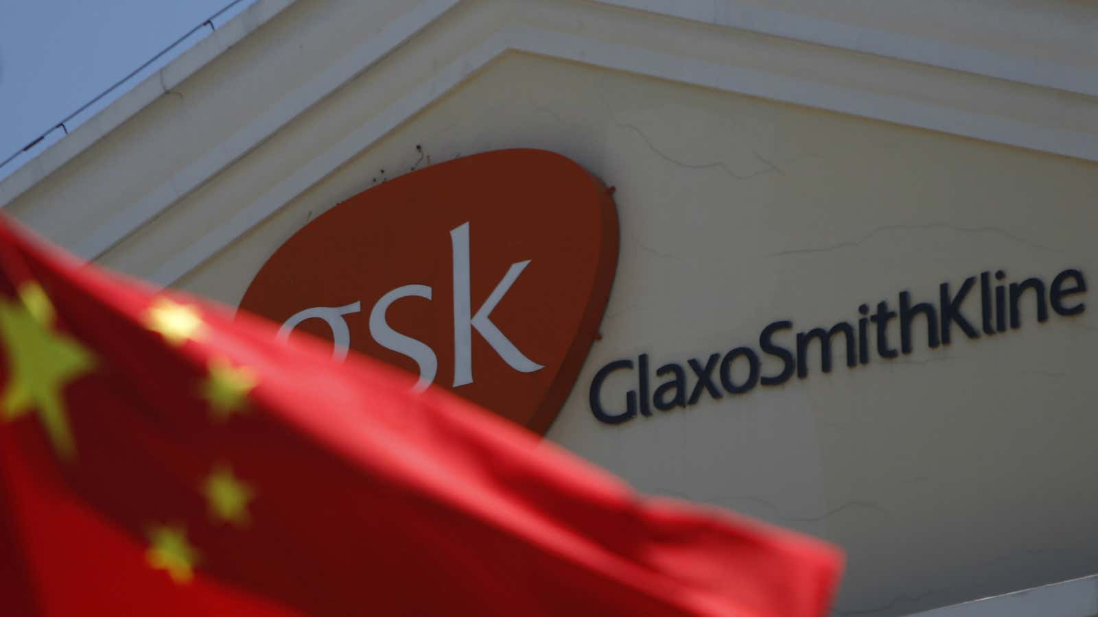 The Chinese flag flies in front of GlaxoSmithKline’s Shanghai office.