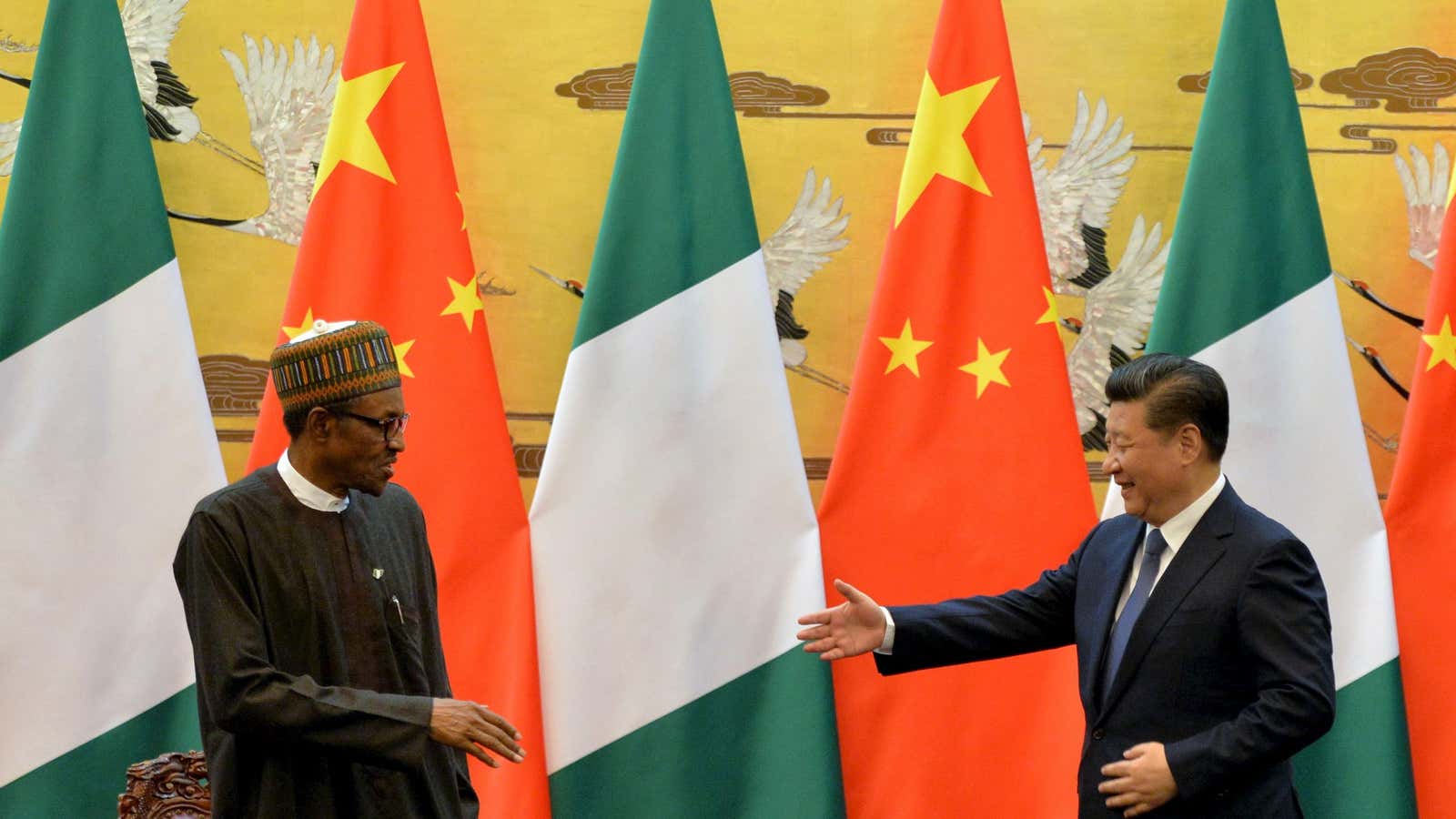 President of the Federal Republic of Nigeria, Muhammadu Buhari (L) and Chinese President, Xi Jinping shake hands during a signing ceremony at the Great Hall of the People in Beijing, April 12, 2016. REUTERS/Kenzaburo Fukuhara/Pool – GF10000379897