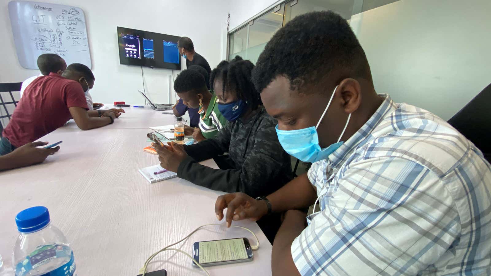 People use their phones during a coding training class in Lagos, Nigeria.