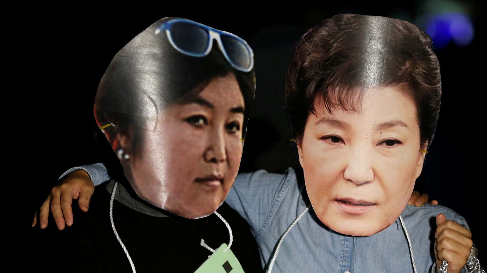 Protesters wearing cut-out of South Korean president Park Geun-hye (R) and Choi Soon-sil attend a protest denouncing Park over a recent influence-peddling scandal in Seoul, South Korea, Oct. 27, 2016.