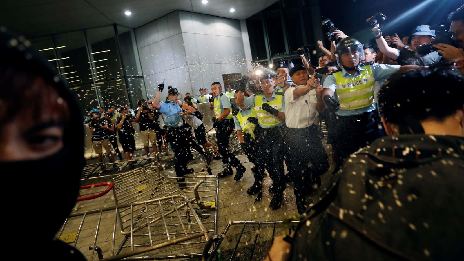 Hong Kong police use pepper spray on protestors.