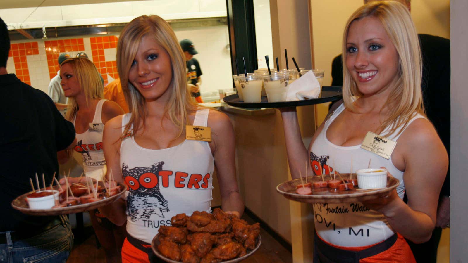 Waitresses serve food and beverages at the opening celebration of the first Israeli branch of Hooters Restaurants in Netanya, near Tel Aviv November 27, 2007.