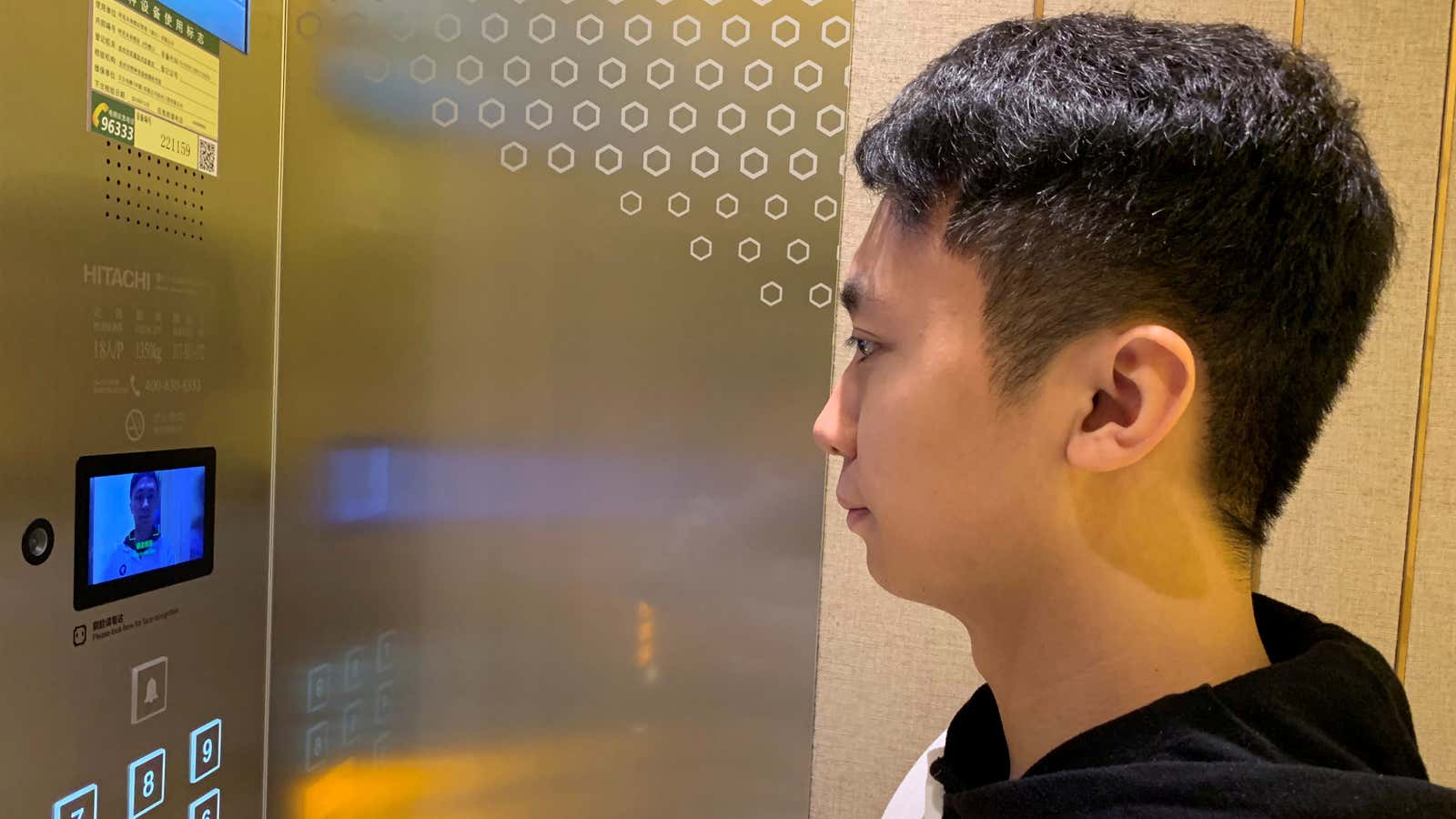 A staff member has his face scanned at an elevator during a demonstration to the media at Alibaba’s FlyZoo hotel in China.