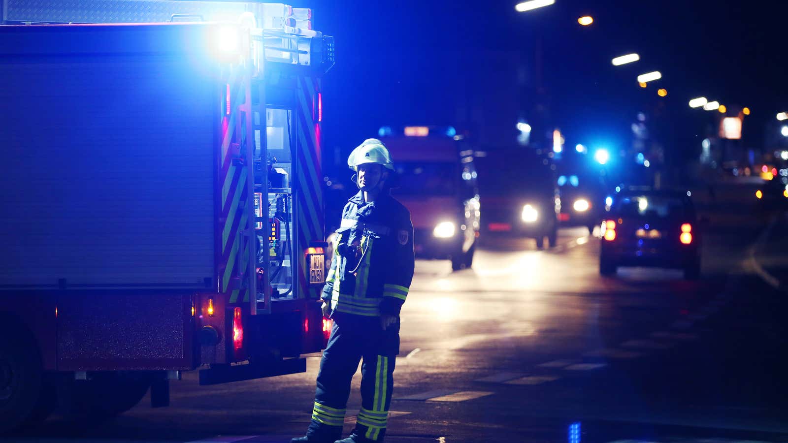 A firefighter stands at a road block in Wuerzburg, Germany on July 18, 2016.